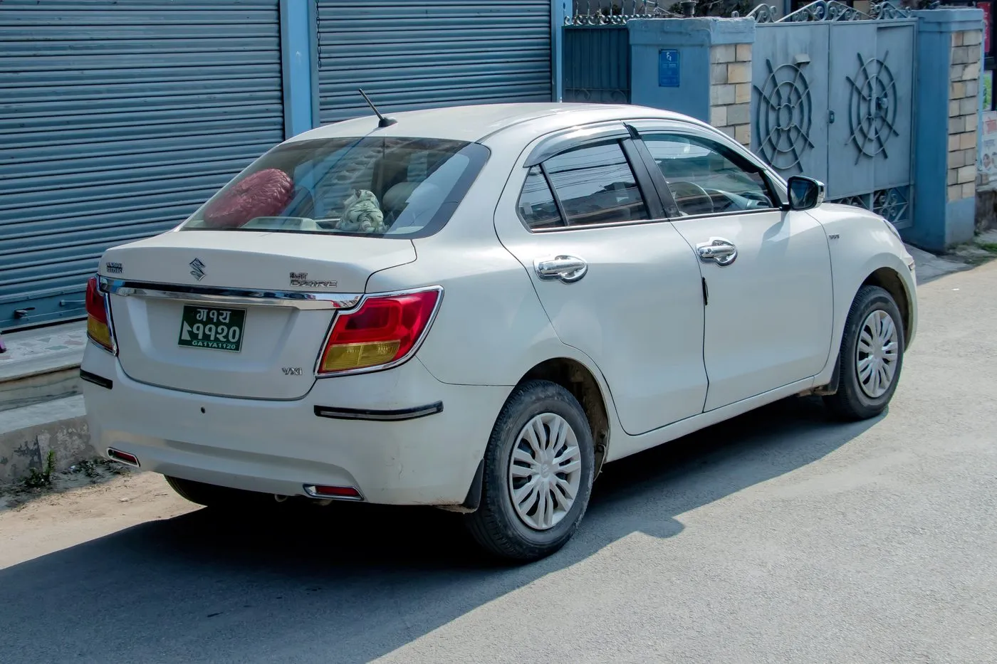 A clean white sedan available for Pokhara airport runs and city tours